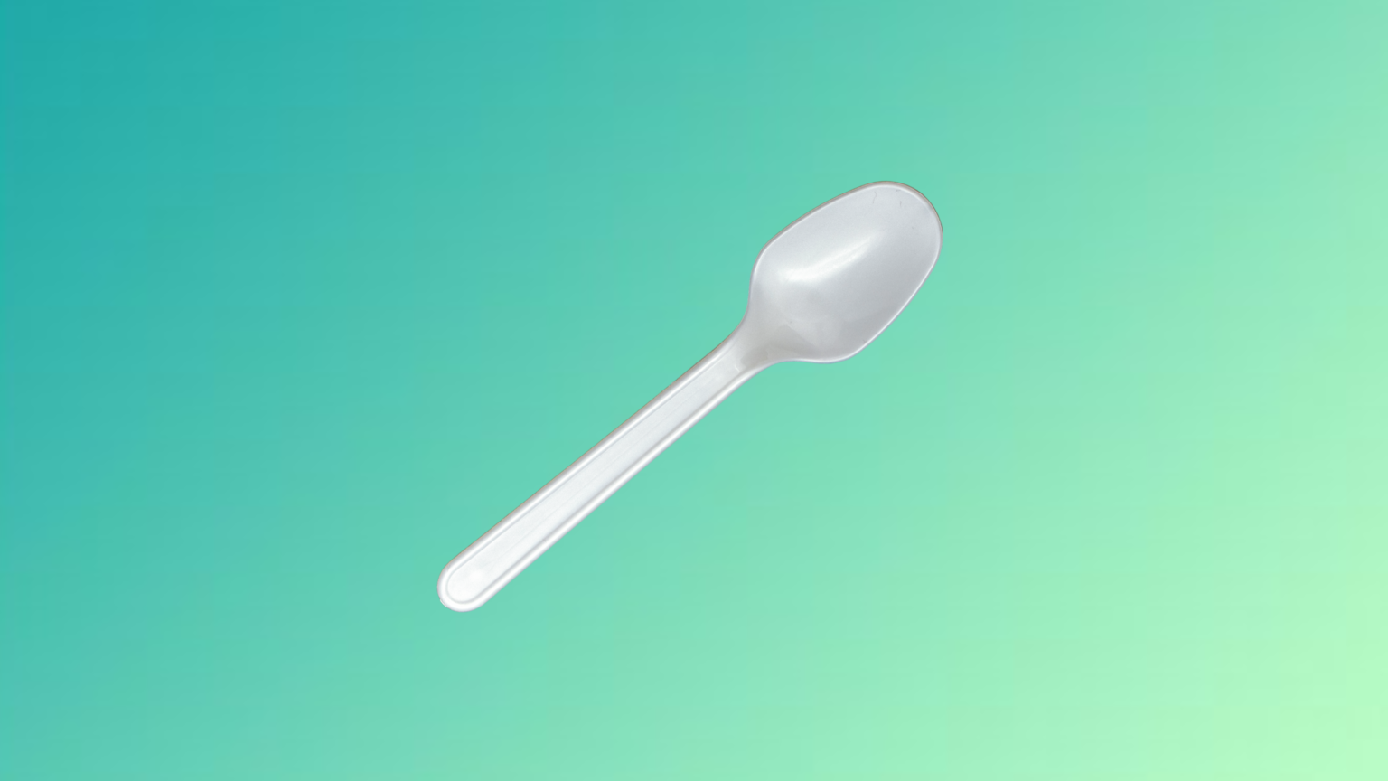 white compostable spoon with a green gradient background